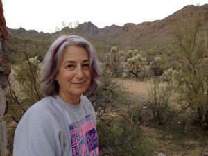 At the stone house. framed by the Tucson Mountains in the background